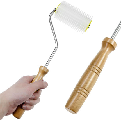 QWORK honey extraction tool being rolled over a honeycomb frame for perforation