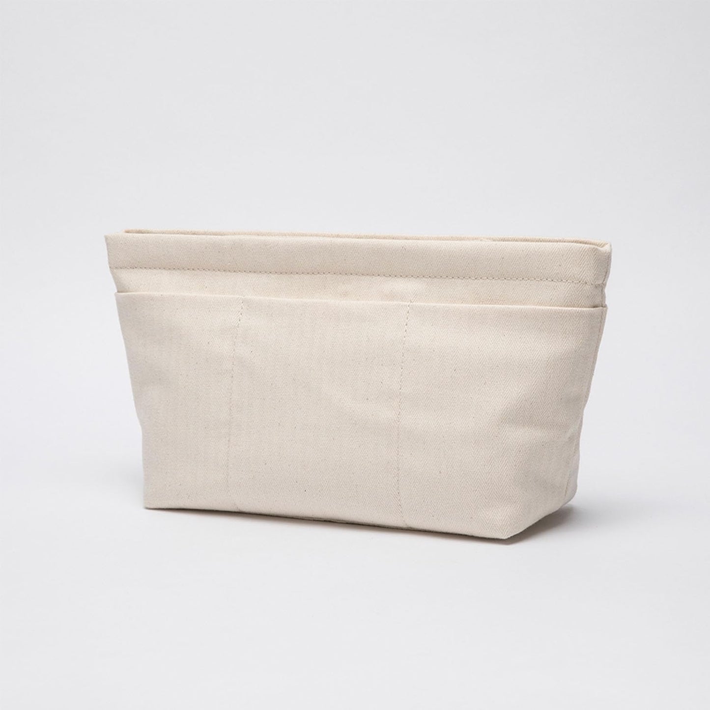 Beige cotton canvas purse shaper liner displaying its lightweight and portable structure close up