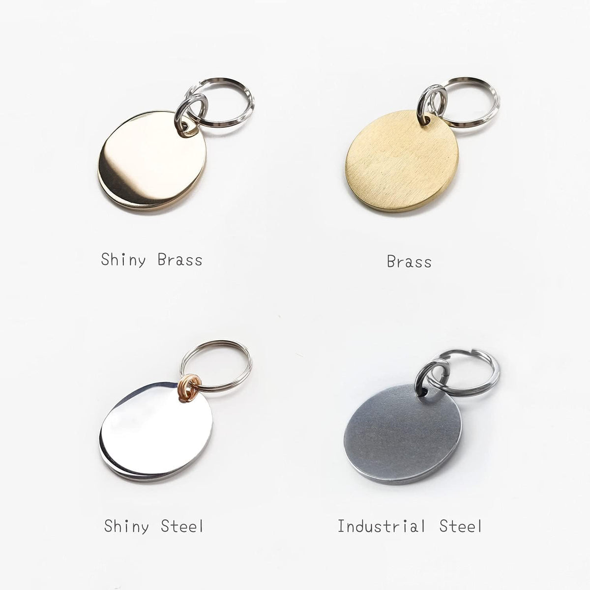 Extra small stainless steel cat identity tag with paw print symbol attached to a small collar.
