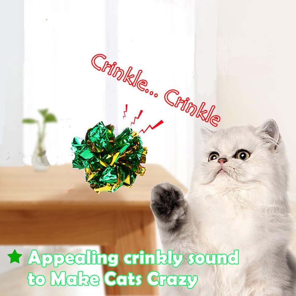A kitten pouncing on a shiny soft mylar independent cat play ball