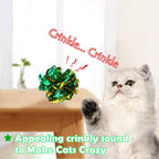 A kitten pouncing on a shiny soft mylar independent cat play ball