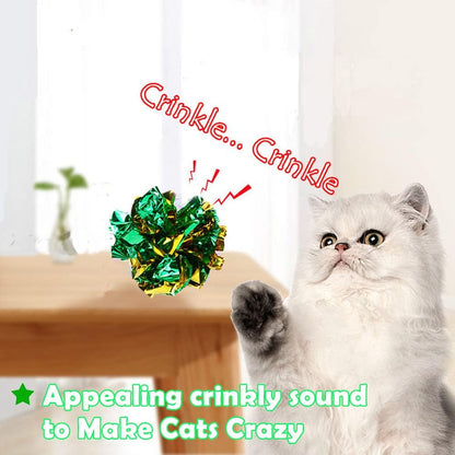 A kitten pouncing on a shiny soft mylar independent cat play ball