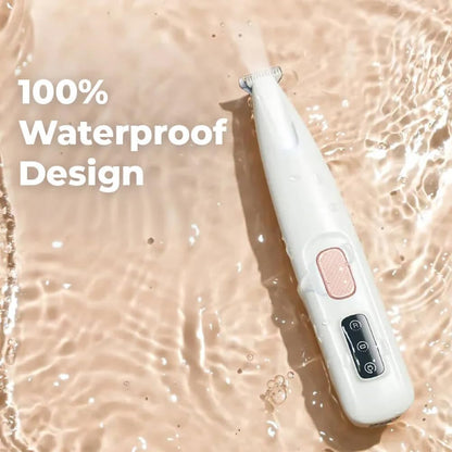 Waterproof cat paw hair trimmer being rinsed under running tap water for easy cleaning.