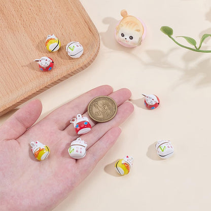 Close up of Japanese Maneki Neko cat charm with key ring
