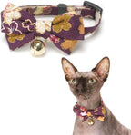 Detailed shot of the gold bell and signature charm on the Necoichi collar.