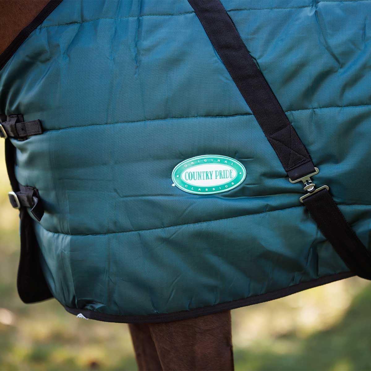 Green channel quilt horse blanket showing adjustable bias surcingles
