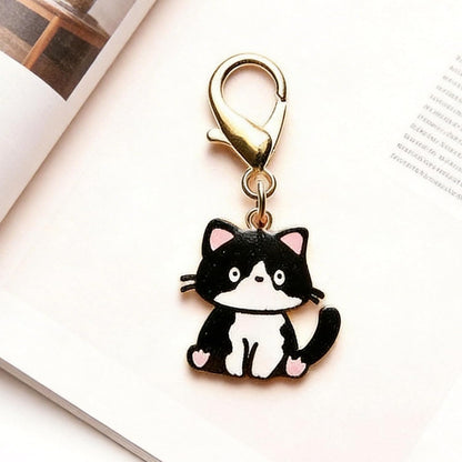 Enamel cat keychain hanging from car keys