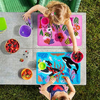 Munchkin WildLove reversible placemat laid flat on a modern family dining table setting
