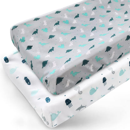 Springspirit diaper changing pad cover front view showcasing grey dinosaur and white ocean animal prints in a nursery setting.