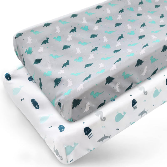 Springspirit diaper changing pad cover front view showcasing grey dinosaur and white ocean animal prints in a nursery setting.
