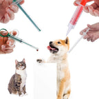 Red pet pill popper syringe tool designed for solid tablets and capsules.