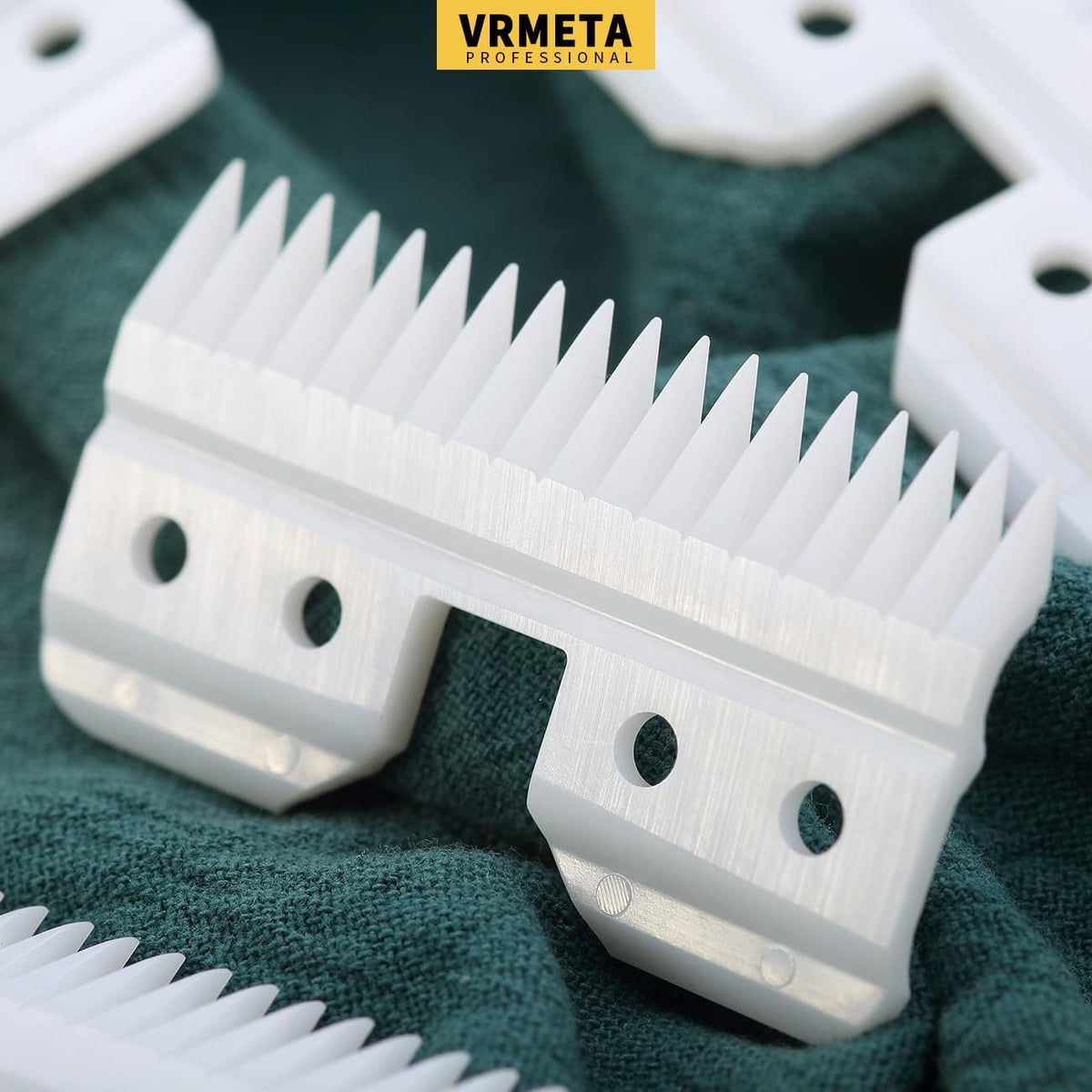 Four pieces of white ceramic clipper blades displayed on a clean background