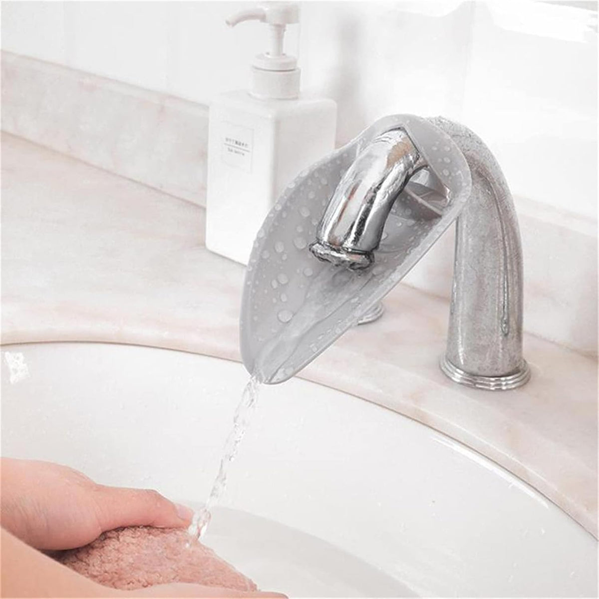 Calsgkspray faucet extender for toddlers front view showing grey silicone leaf design attached to a bathroom tap