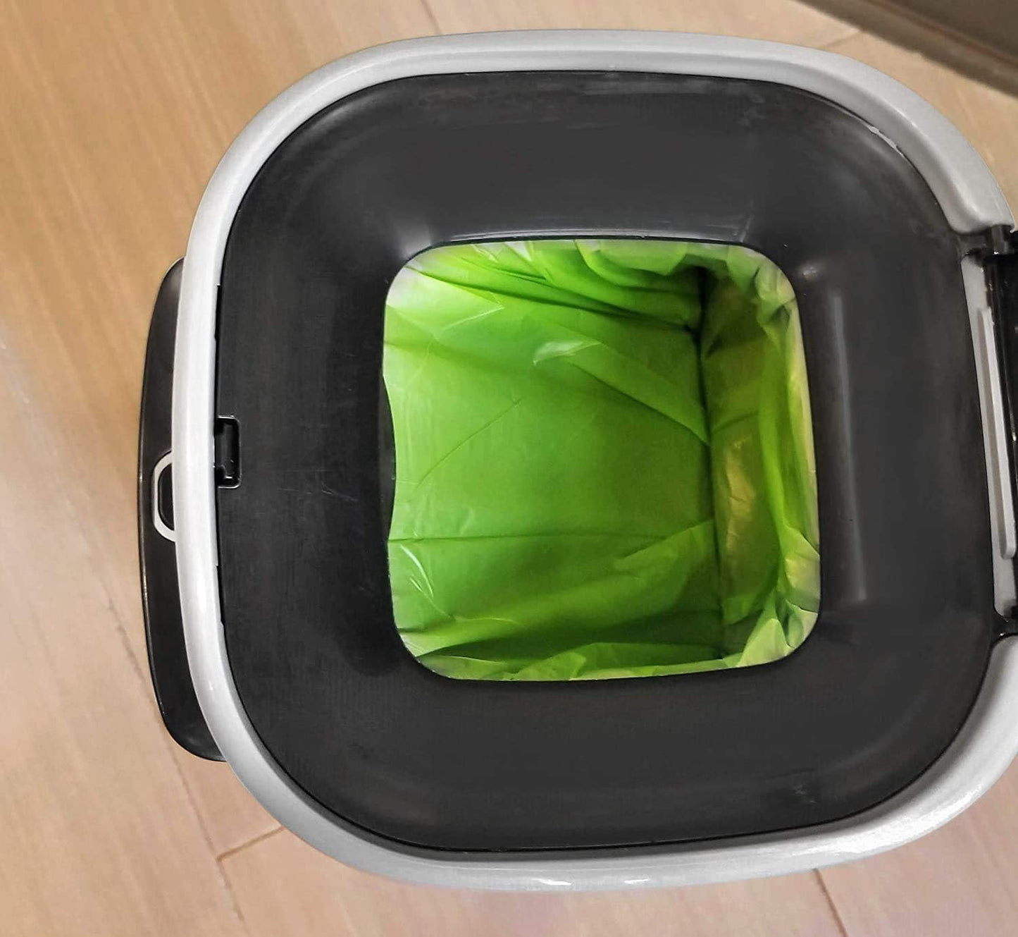 Heavy duty tear proof opaque green pet waste bags demonstrating thickness and durability.