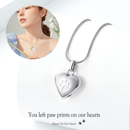 Close up of heart urn pendant with paw print engraving