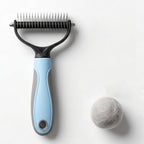 UJEAVETTE Vivanchor Pet Pro Deshedder front view showing blue ergonomic handle and dual-sided stainless steel teeth