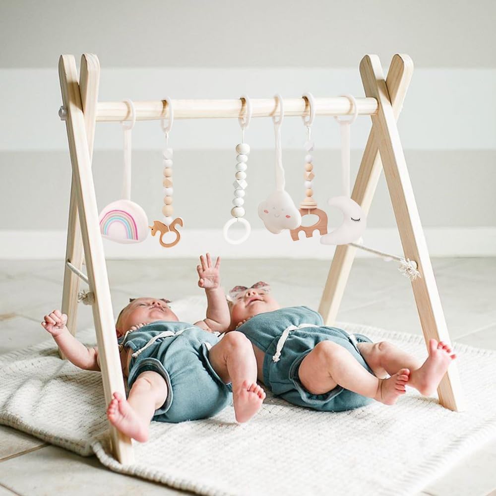 Mallify wooden baby gym front view showcasing the natural pine wood A-frame and hanging sensory toys.