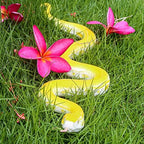 SIENON realistic snake toy rubber figurine coiled on a patio surface.