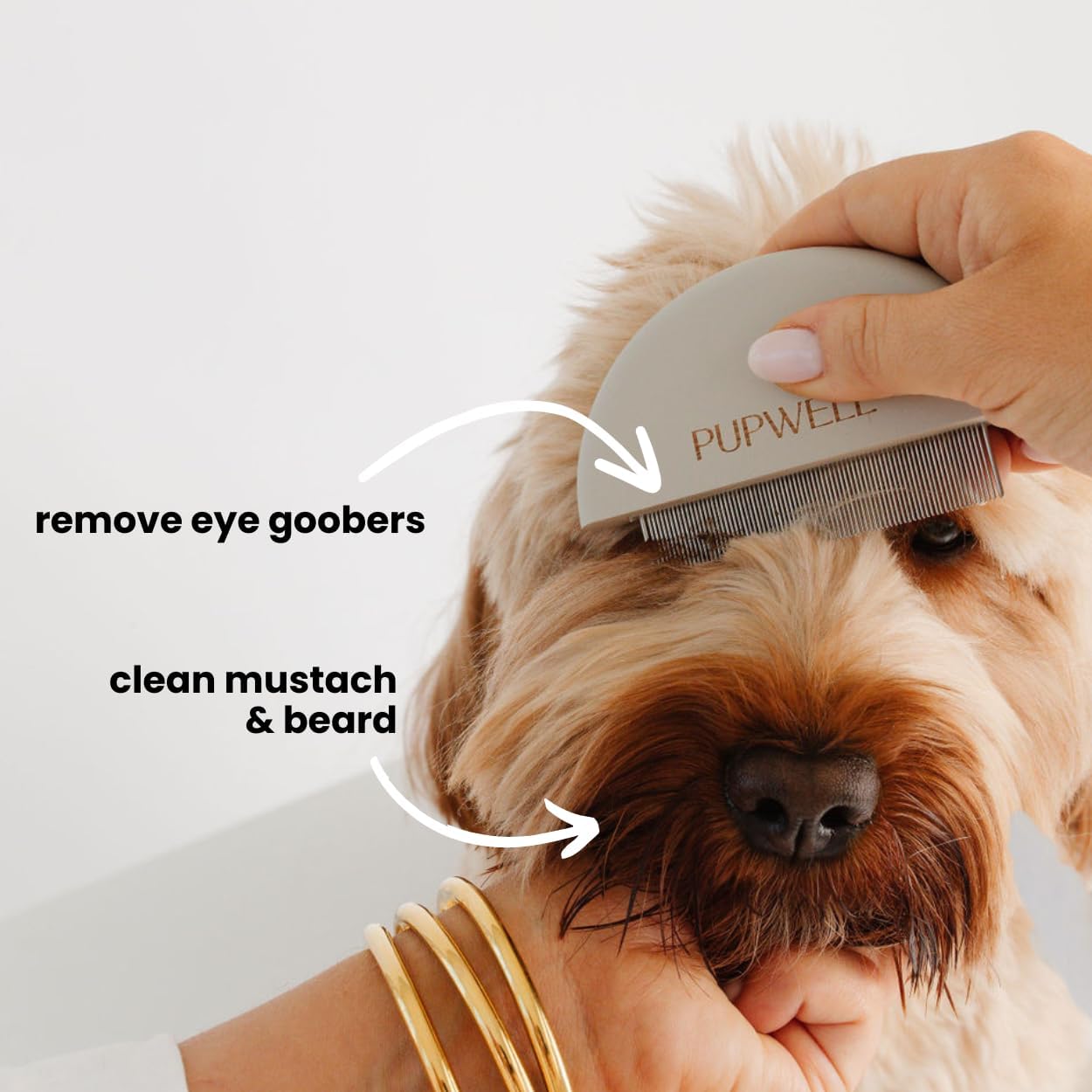 Pupwell pet grooming comb highlighting the tightly spaced stainless steel teeth for eye gunk removal.