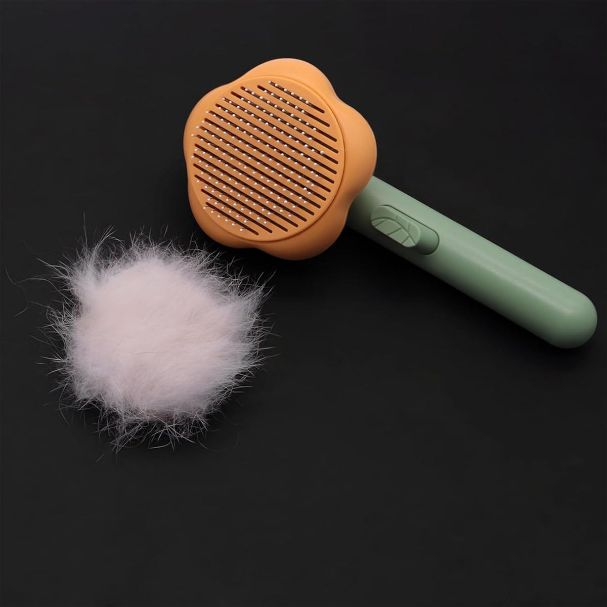 Mixen small animal grooming tool being used to remove undercoat loose hair from a cat.