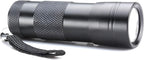 Water resistant portable inspection torch illuminated in a dark room environment.