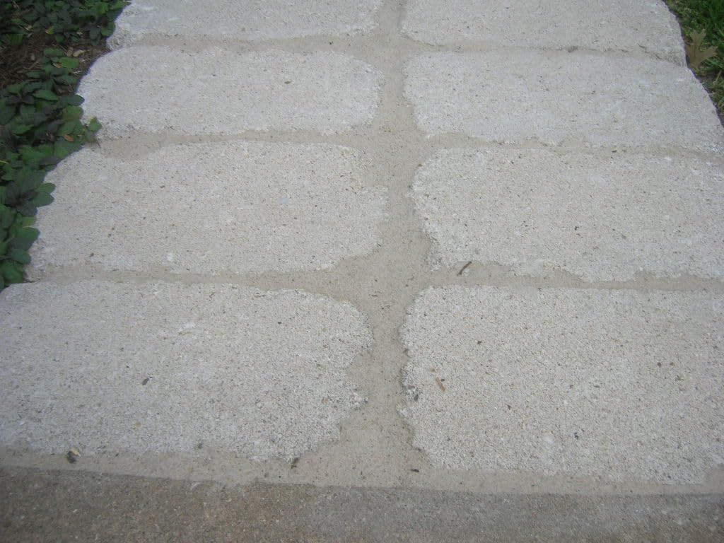 Polymeric sand being applied to concrete driveway pavers