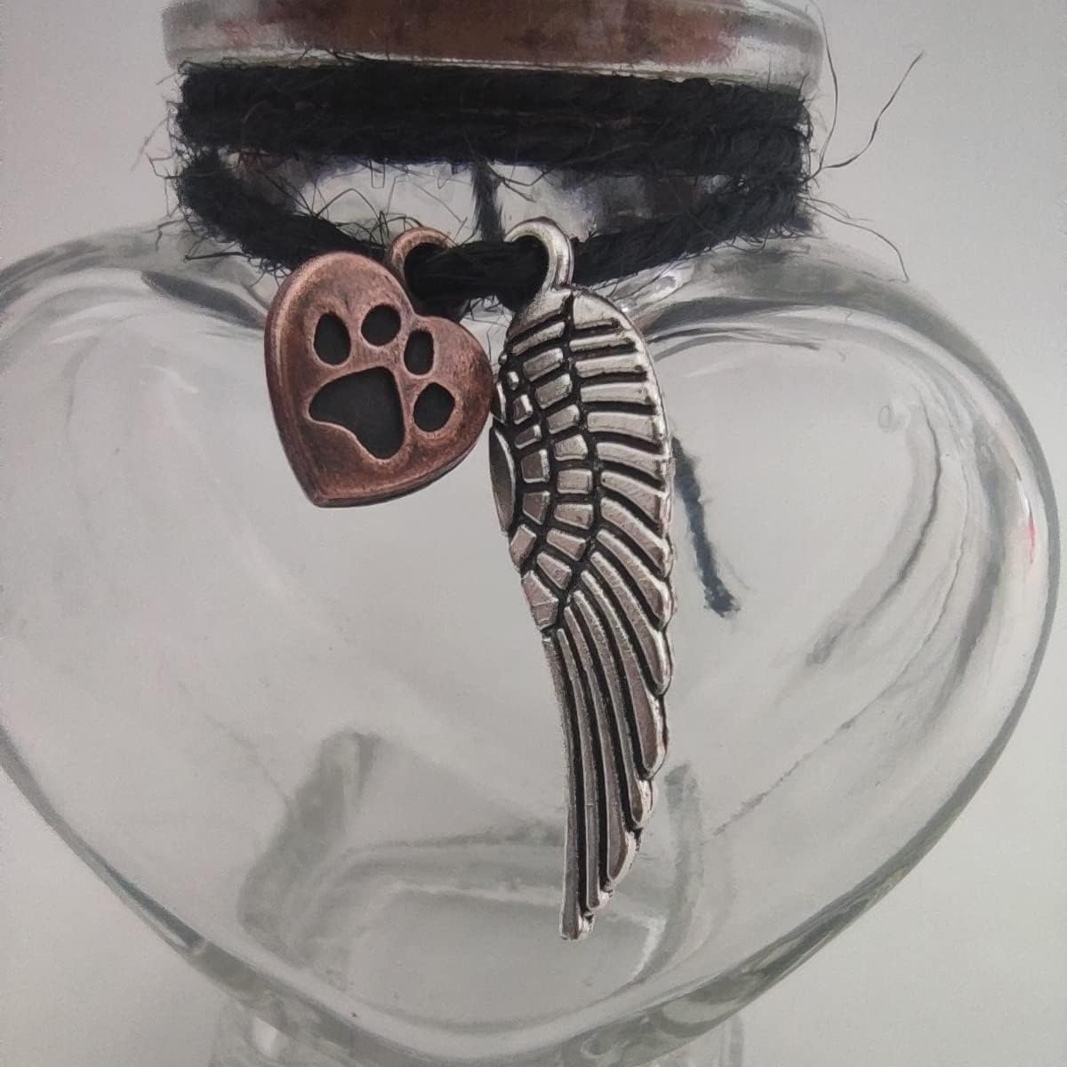 Close up of Fight Club glass memorial urn with metal charms