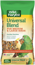 Small bird eating from a feeder filled with Wild Harvest blend