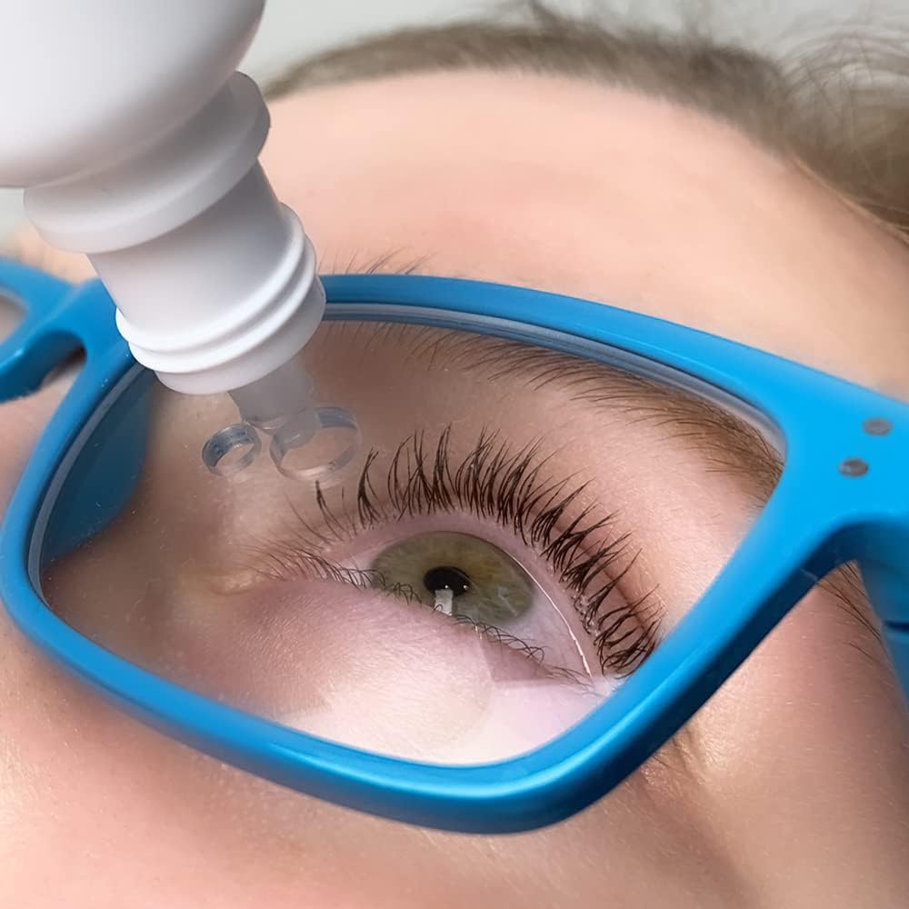 Easy Eye Drops aid glasses front view showing built-in bottle openings for accurate alignment.