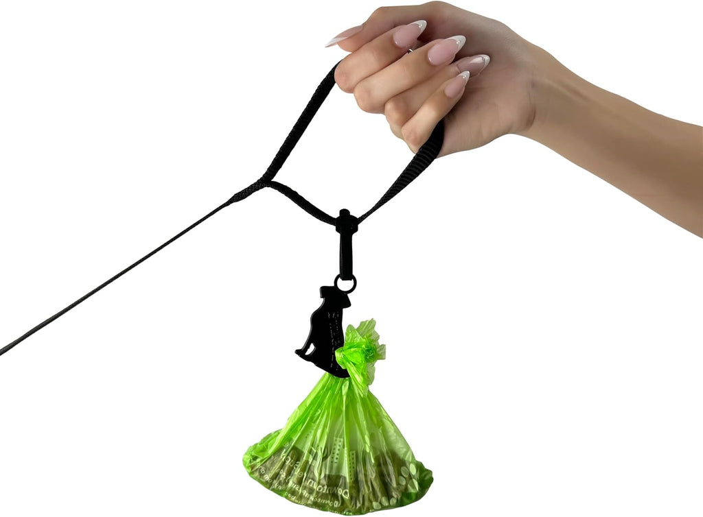 Hands free pet waste bag holder hanging a used bag during an outdoor walk