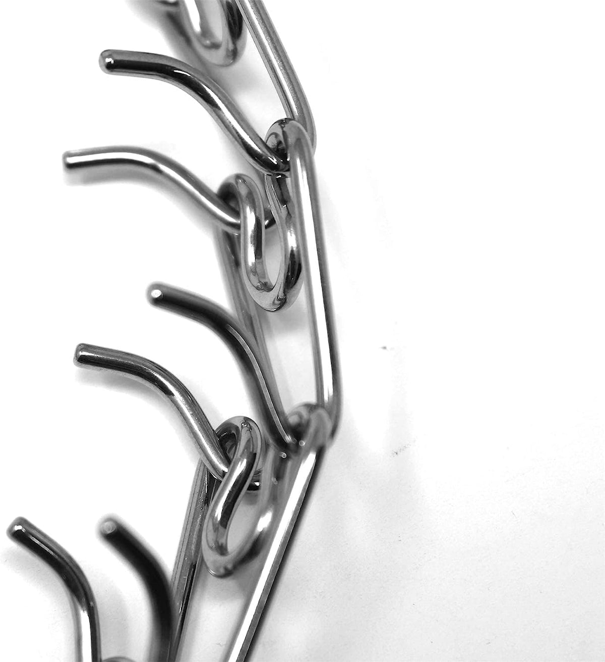 Small size Herm Sprenger dog training collar with interlocking links being unlinked for adjustment.