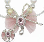 Adjustable pink bow dog necklace charm for small dog breeds like Chihuahuas and Yorkies.