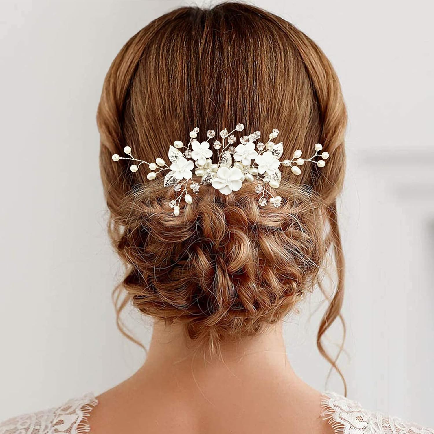 PrettyLife flower bridal hair vine front view showing white clay flowers and pearls.