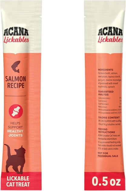ACANA Lickables salmon purÃ©e treat being hand fed to a cat