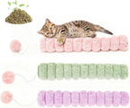 Small kitten snuggling with soft candy shaped cat toy