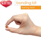 Pet bird eating a Kaytee Bonding Bit from a hand.