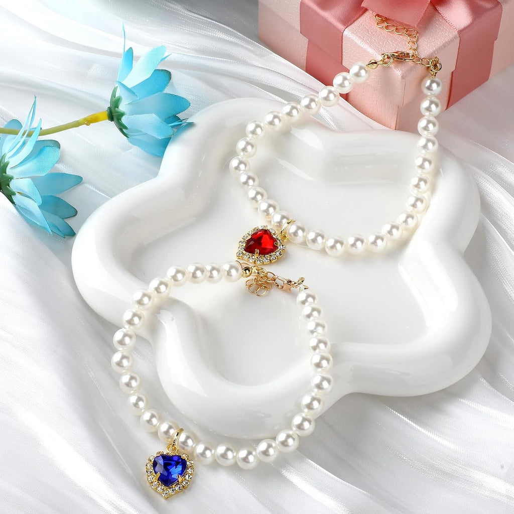 Two piece set of pet pearl jewelry accessories with adjustable extender chain displayed on white background