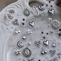 Nbntgh silver nail art stickers front view showing 5D embossed heart and star designs