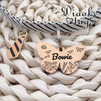 Laser engraved metal pet identification tag with four lines of custom text.