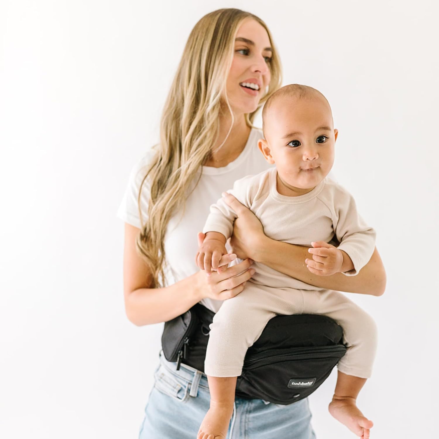 TushBaby Original Hip Seat Baby Carrier in black showing front view waist belt design.
