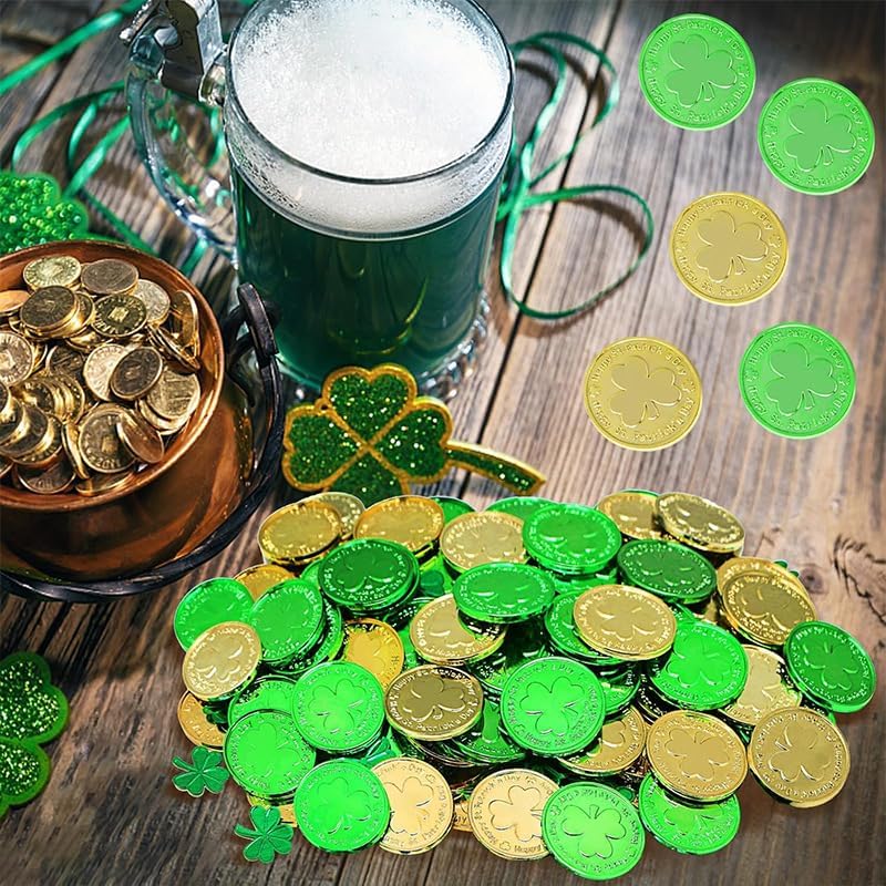 A mix of metallic gold and green plastic lucky coins scattered on a white surface