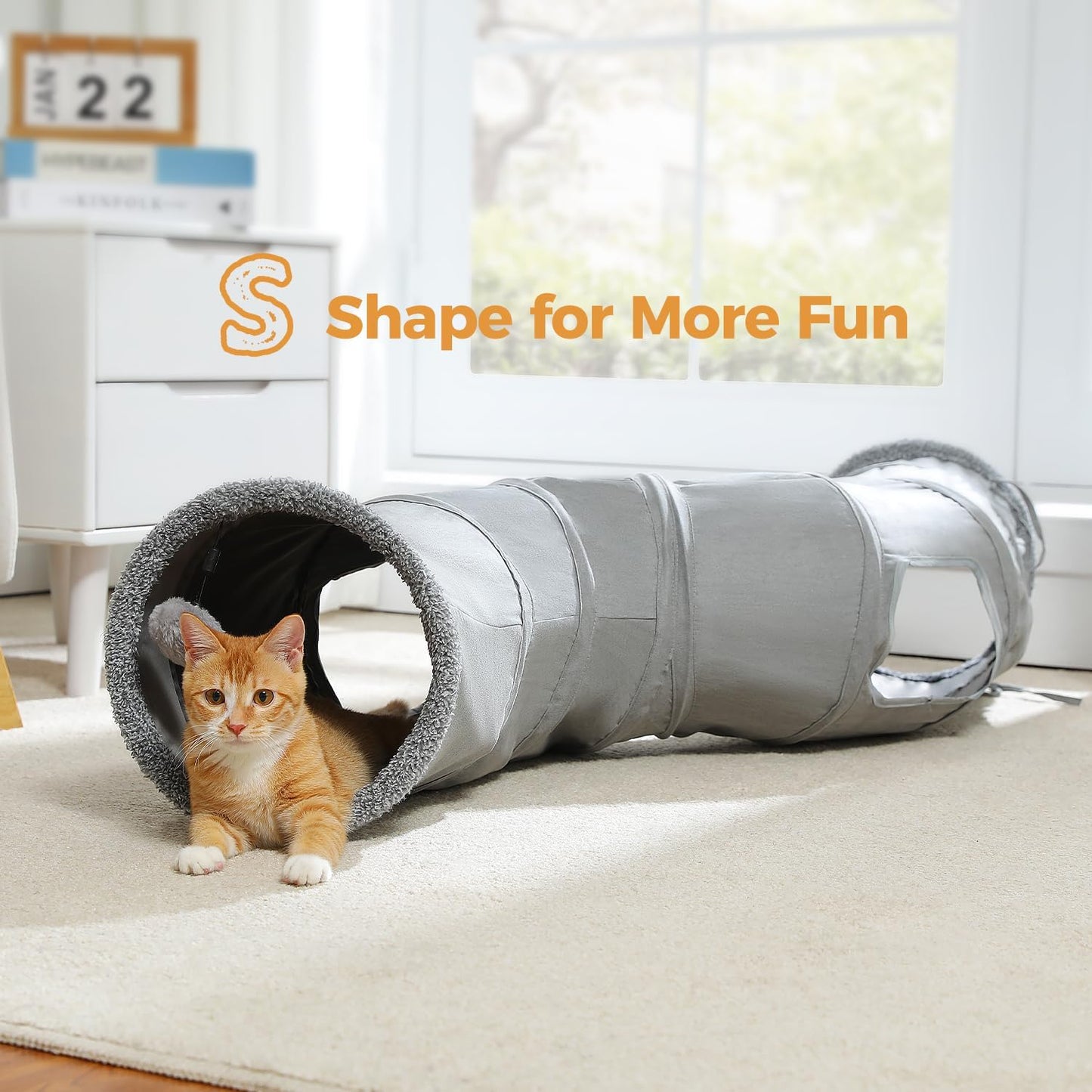 An adult cat peeking out from one of the built-in interactive peek holes.
