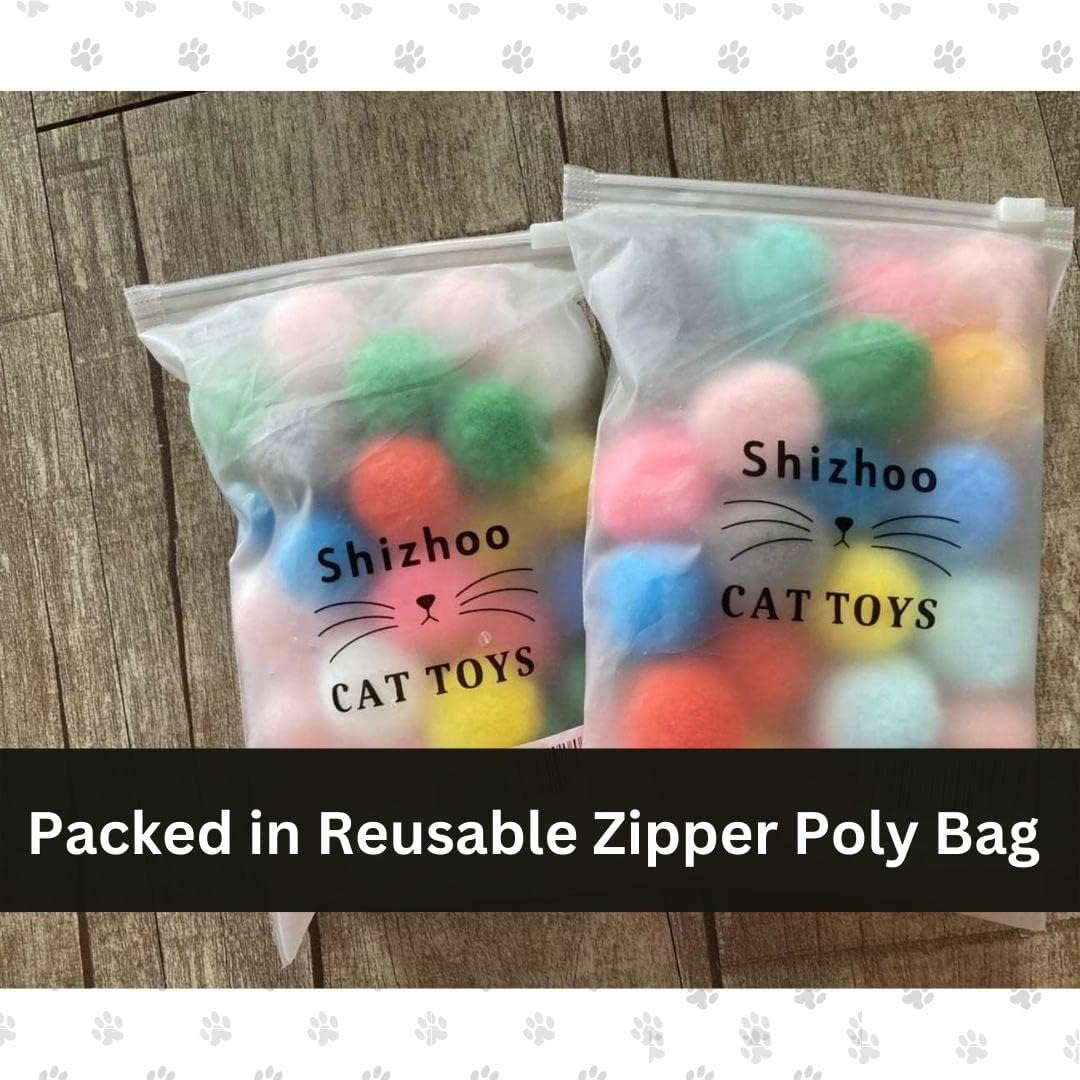 Kitten batting a colorful 1.2 inch Shizhoo plush toy ball on the floor.