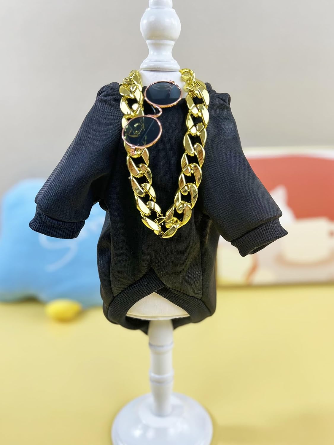 Small size pet hoodie clothing with stylish accessories laid out on a flat surface