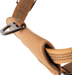 Side view of medium brown adjustable dog harness on white background