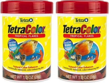 Hand holding 185 milliliter TetraColor Tropical Flakes container