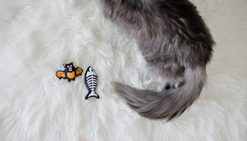 Pearhead Pawloween cat toy set showing the detailed textured fabrics of the fish skeleton and bat.