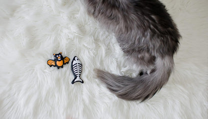 Pearhead Pawloween cat toy set showing the detailed textured fabrics of the fish skeleton and bat.