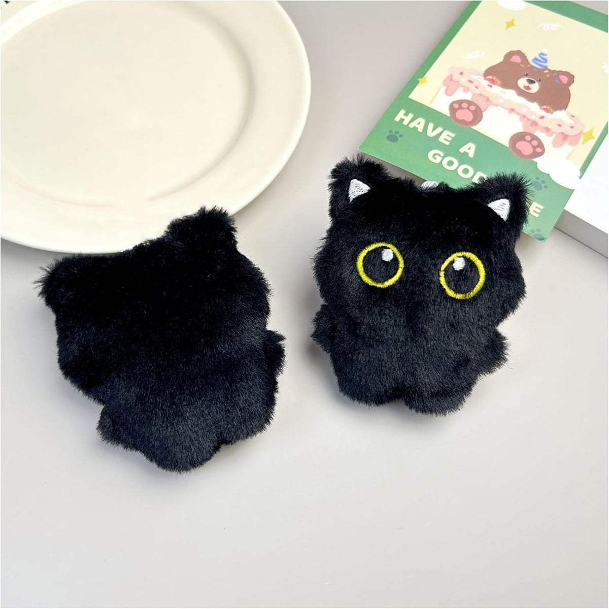 Pmeixcy interactive cat plush set being squeezed to showcase squeaker feature