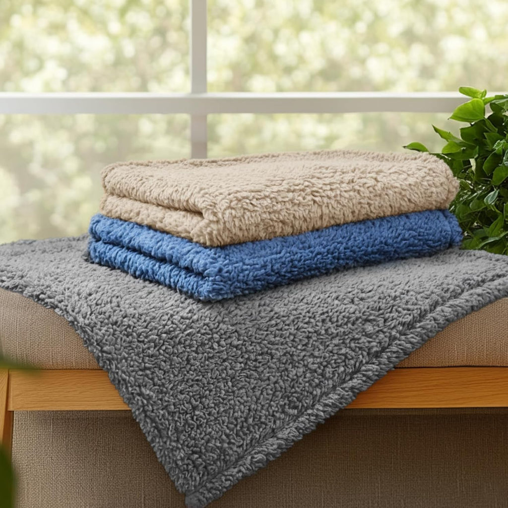 Luciphia machine washable fleece blanket being placed into a home washing machine.